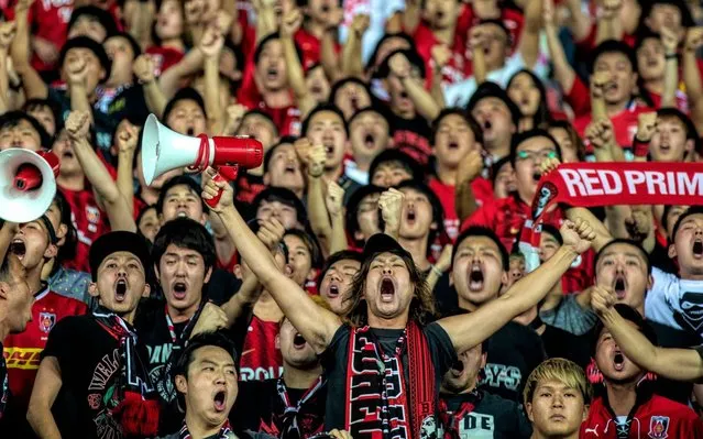 Supporters of Urawa Red Diamonds cheer before the AFC Champions League semi final second leg match between Guangzhou Evergrande ​and Urawa Red Diamonds in Guangzhou, China, 23 October 2019. (Photo by Alex Plavevski/EPA/EFE)