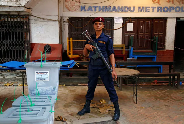 A Nepalese policeman stands guard in front of sealed ballot boxes stored awaiting transportation, after the completion of the local election of municipalities and villages representatives in Kathmandu, Nepal May 14, 2017. (Photo by Navesh Chitrakar/Reuters)