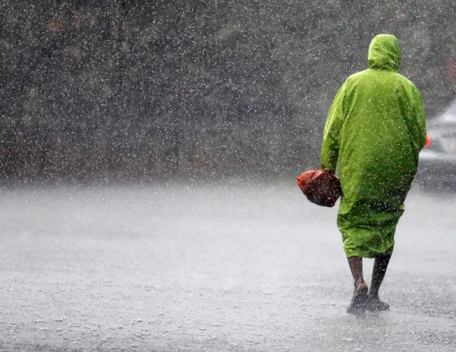 A man walks in the rain at the Galle Dutch Fort in Sri Lanka May 28, 2016. (Photo by Dinuka Liyanawatte/Reuters)