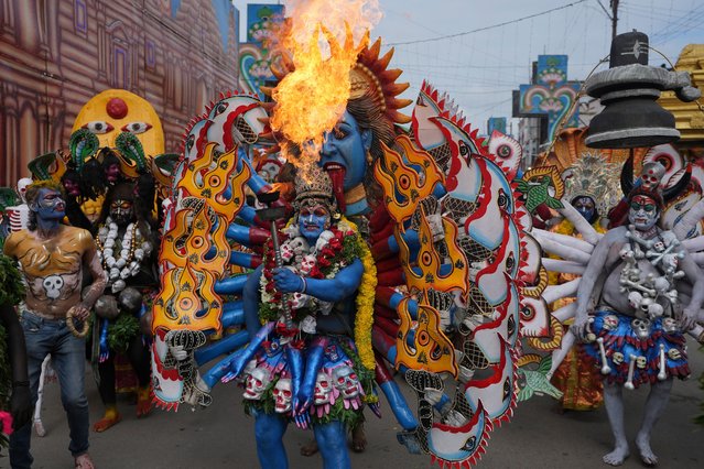 An artist dressed as Hindu goddess Mahakali performs during a procession marking “Bonalu” festival in Hyderabad, India, Monday, July 29, 2024. (Photo by Mahesh Kumar A./AP Photo)