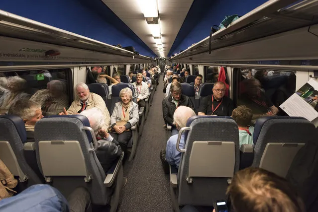 Happy winners of tickets for the first train through the Gotthard tunnel enjoy their trip from Arth-Goldau to Bellinzona, Switzerland, on the opening day of the Gotthard rail tunnel, the longest tunnel in the world, 01 June 2016. (Photo by Christian Beutler/EPA)