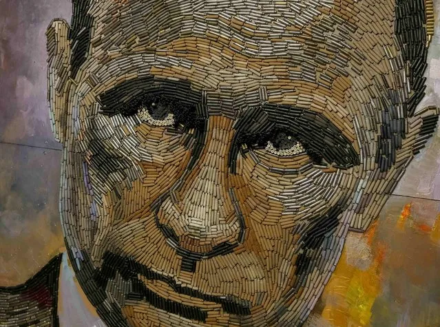 A portrait of Russian President Vladimir Putin, made out of 5,000 cartridges brought from the frontline in eastern Ukraine, named “The Face of War” is seen in the studio of Ukrainian artist Dariya Marchenko, in Kiev, July 23, 2015. (Photo by Gleb Garanich/Reuters)