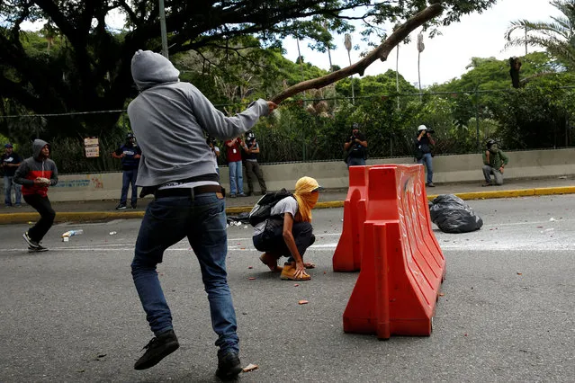 Demonstrators clash with riot police officers during a protest called by university students against Venezuela's government in Caracas, Venezuela, June 9, 2016. (Photo by Carlos Garcia Rawlins/Reuters)