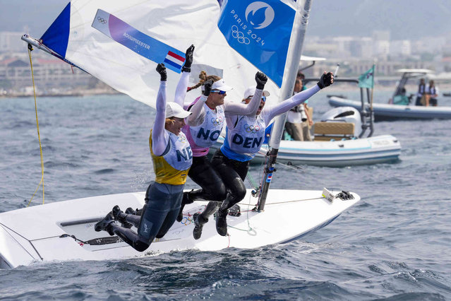 From left, three medalists Marit Bouwmeester of the Netherlands, gold medal, Line Flem Hoest of Norway, bronze medal, and Anne-Marie Rindom of Denmark, silver medal, celebrate at the end of the ILCA 6 women's dinghy class final race during the 2024 Summer Olympics, Wednesday, August 7, 2024, in Marseille, France. (Photo by Carolyn Kaster/AP Photo)