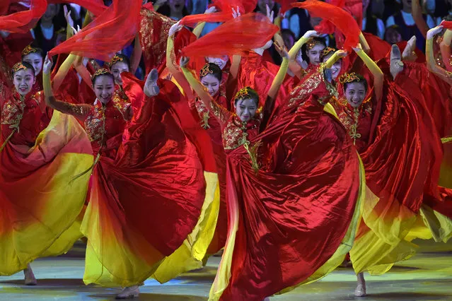 Performers dance during a variety show attended by China's President Xi Jinping in Hong Kong on June 30, 2017. China's President Xi Jinping praised Hong Kong for its role in China's economic development as he addressed a banquet, which included lawmakers and business figures, and told Hong Kong citizens to believe in themselves and China. (Photo by Anthony Wallace/AFP Photo)
