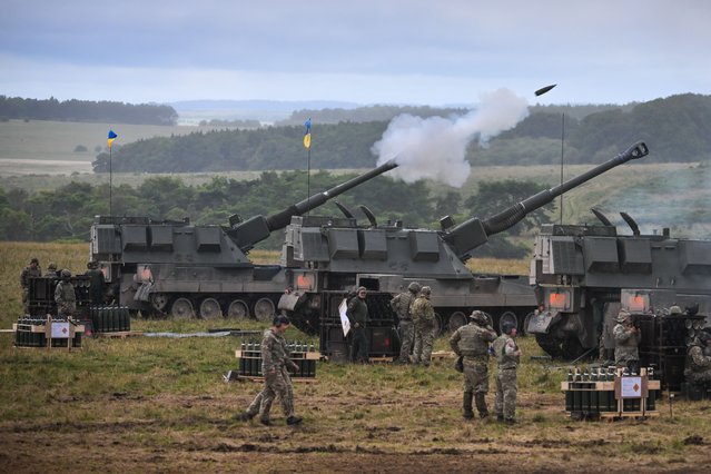 Ukrainian artillery recruits undergo a live fire training exercise on the AS90 155mm self-propelled gun, on July 27, 2023 in South West, England. The UK was the first country to donate Western main battle tanks by gifting a squadron of Challenger 2 tanks with armoured recovery and repair vehicles, as well as a battery of eight AS90 guns at “high readiness” and a further two batteries at “varying states of readiness”. The AS90 is an agile, highly accurate, modern artillery system which provides armoured protection to its crew whilst enabling them to strike targets at long ranges. Over 1,000 UK service personnel are involved in implementing the programme, which is taking place at MOD sites across the North West, South West and South East of the UK. Training on the AS90 is happening at specialist facilities and conducted by officers and soldiers of the Royal Regiment of Artillery. (Photo by Finnbarr Webster/Getty Images)