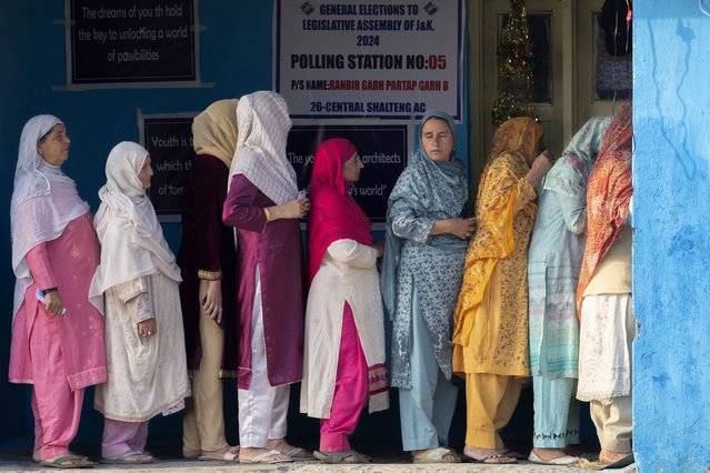 Kashmiri women queue up at a polling booth to cast their vote during the second phase of the assembly election in the outskirts of Srinagar, Indian controlled Kashmir, Wednesday, September 25, 2024. (Photo by Dar Yasin/AP Photo)