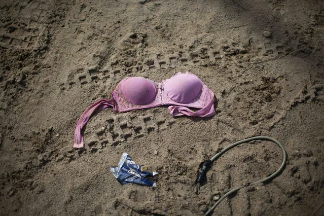 In this Friday, May 16, 2014 file photo, a discarded bra lies on the ground outside an informal bar that allegedly employed s*x workers after a government raid on the illegal mining camp in La Pampa in the Madre de Dios region of Peru. Amnesty International approved a controversial policy Tuesday, August 11, 2015 to endorse the de-criminalization of the s*x trade, rejecting complaints by women's rights groups who say it is tantamount to advocating the legalization of pimping and brothel owning. (Photo by Rodrigo Abd/AP Photo)