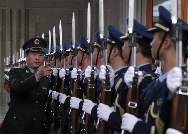An officer inspects an honor guard before an official welcoming ceremony at the Great Hall of the People in Beijing. (Photo by David Gray/Reuters)