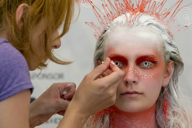 A make-up artist prepares a model for the 'creative make-up' competition during the third day of the 20th World Bodypainting Festival 2017 on July 30, 2017 in Klagenfurt, Austria. (Photo by Jan Hetfleisch/Getty Images)