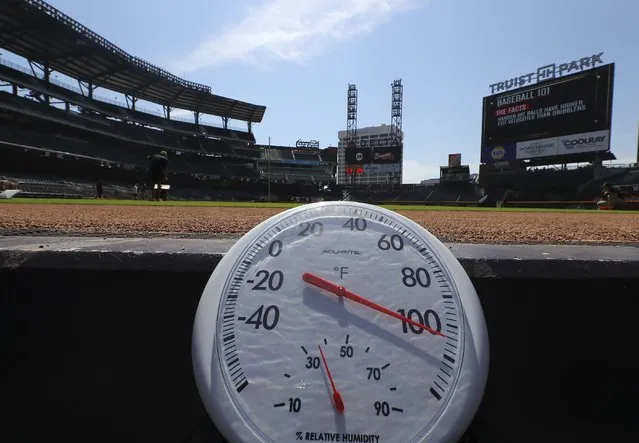 Temperature shows over 100 degrees before a baseball game between the Atlanta Braves and San Francisco Giants at Truist Park in Atlanta, Thursday, June 23, 2022. A heat wave that's already lasted more than a week keeps on baking the US, Asia, Europe and even the Arctic. (Photo by Curtis Compton/Atlanta Journal-Constitution via AP Photo)