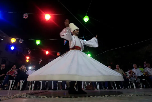 A whirling Dervish performs on stage during the Muslim fasting month of Ramadan in Sidon, southern Lebanon June 29, 2016. (Photo by Ali Hashisho/Reuters)