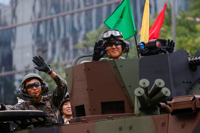 South Korean servicemen onboard a military vehicle wave to citizens during a military parade to mark the 76th anniversary of the armed forces day in Seoul, South Korea, on October 1, 2024. (Photo by Kim Soo-hyeon/Reuters)