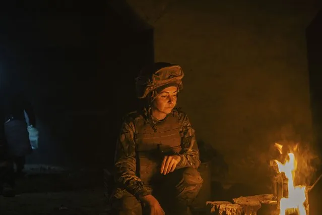 In this photo provided by Azov Special Forces Regiment of the Ukrainian National Guard Press Office, A Ukrainian woman soldier inside the ruined Azovstal steel plant take a rest in his shelter in Mariupol, Ukraine, May 10, 2022. For nearly three months, Azovstal’s garrison clung on, refusing to be winkled out from the tunnels and bunkers under the ruins of the labyrinthine mill. A Ukrainian soldier-photographer documented the events and sent them to the world. Now he is a prisoner of the Russians. His photos are his legacy. (Photo by Dmytro Kozatsky/Azov Special Forces Regiment of the Ukrainian National Guard Press Office via AP Photo)