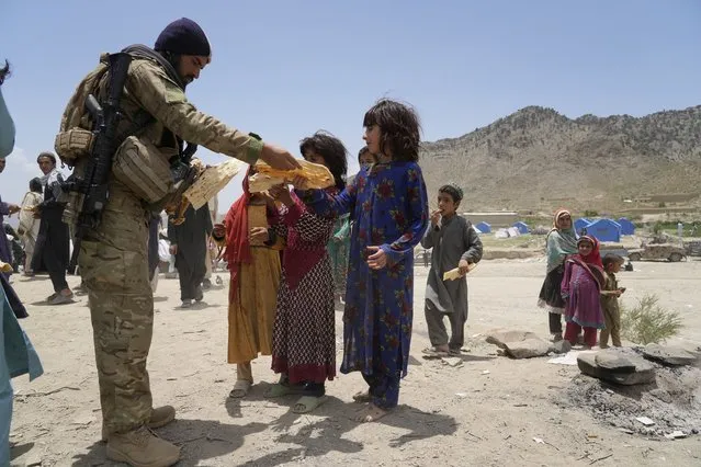 Afghans receive aid at a camp after an earthquake in Gayan district in Paktika province, Afghanistan, Sunday, June 26, 2022. (Photo by Ebrahim Nooroozi/AP Photo)