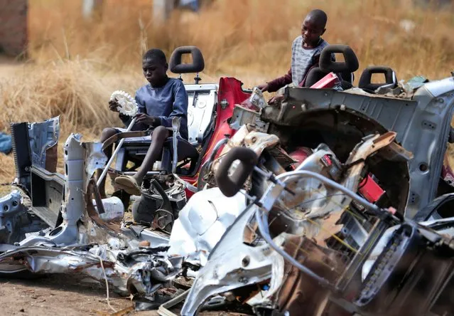 Kids play at a scrap metal collection point in Hopley, a poor settlement about 15 kilometres west of Zimbabwe's capital, Harare, Zimbabwe on July 22, 2022. (Photo by Philimon Bulawayo/Reuters)