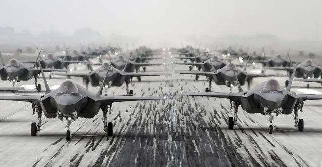 In this photo provided by South Korea Defense Ministry via Yonhap News Agency, South Korean Air Force's F-35A stealth fighters perform an elephant walk at an unidentified air base, South Korea, Friday, March 25, 2022. (Photo by South Korea Defense Ministry/Yonhap via AP Photo)