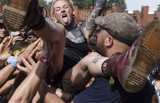 A woman crowdsurfs during the 15th edition of the Hellfest metal music festival in Clisson, western France on June 23, 2019. (Photo by Sebastien Salom Gomis/SIPA Press)