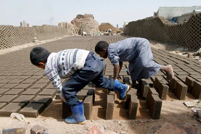 Boys arrange blocks at a brick factory on the outskirt of Sanaa, Yemen May 28, 2016. (Photo by Mohamed al-Sayaghi/Reuters)