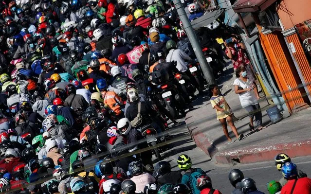 Motorcycle riders crowd a military checkpoint in Las Pinas city, Metro Manila, Philippines, 20 April 2020. According to reports, Philippine President Rodrigo Duterte has threatened a martial law-like crackdown in case the number of quarantine violators continues to rise. Police said more than 100,000 individuals have violated the quarantine protocols – caught outside their homes without valid reasons. (Photo by Francis R. Malasig/EPA/EFE/Rex Features/Shutterstock)