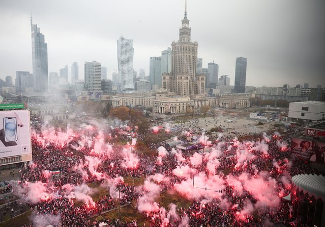 People light flares as they attend a march to mark the 105th anniversary of Polish independence in Warsaw, Poland on November 11, 2023. (Photo by Kacper Pempel/Reuters)