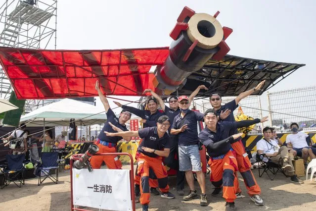 Team members from “Firefighting Life” poses with their man made flying machine in Taichung, a port city in central Taiwan on Sunday, September 18, 2022. Pilots with homemade gliders launched themselves into a harbor from a 20-foot-high ramp to see who could go the farthest before falling into the waters. It was mostly if not all for fun as thousands of spectators laughed and cheered on 45 teams competing in the Red Bull “Flugtag” event held for the first time. (Photo by Szuying Lin/AP Photo)