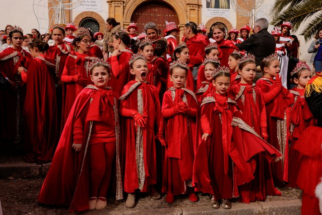 Women and girls dressed up as dancers watch the arrival of men dressed as the Three Wise Men during the traditional Epiphany parade, which was brought forward exceptionally to midday, instead of at traditional night as in other Spanish cities, due to the threat of rain, in Ronda, Spain on January 5, 2025. (Photo by Jon Nazca/Reuters)