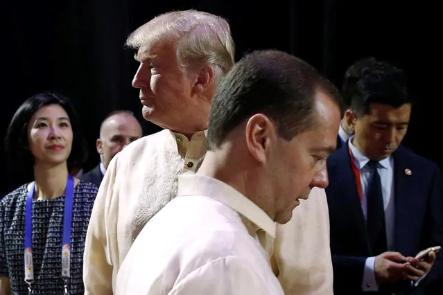 Russia's Prime Minister Dmitry Medvedev (L) crosses paths with U.S. President Donald Trump at the Association of Southeast Asian Nations (ASEAN) Summit gala dinner in Manila, Philippines November 12, 2017. (Photo by Jonathan Ernst/Reuters)