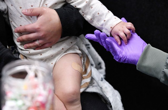 Sherry Andrews, right, holds the hand of 13-month-old Jaqi Herrera after administering a measles-mumps-rubella vaccine in Lubbock, Texas, on Thursday, February 27, 2025. A measles outbreak in Texas has grown to at least 159 cases this week, and the US Centers for Disease Control and Prevention says it is now on the ground in that state to respond. (Photo by Annie Rice/Reuters)