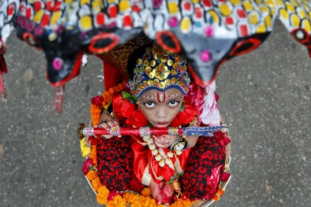 A Bangladeshi child dressed as Hindu God Krishna participates in a procession to celebrate “Janmashtami” in Dhaka, Bangladesh, Thursday, August 25, 2016. The Janmashtami festival marks the birthday of Hindu God Krishna. (Photo by A.M. Ahad/AP Photo)