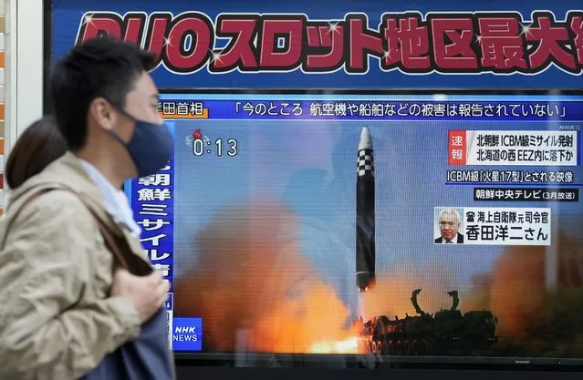 Pedestrians walk past a street television showing news of North Korea firing a ballistic missile on a street in Tokyo, Japan, 18 November 2022. North Korea launched what is believed to be an intercontinental ballistic missile (ICBM), which landed inside Japan's exclusive economic zone (EEZ), about 200 km west of Oshima-Oshima island of Japanese northern island of Hokkaido. (Photo by Kimimasa Mayama/EPA/EFE)