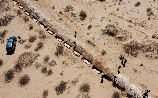 This aerial view shows the burial in a mass grave at the San Rafael municipal cemetery of 56 unidentified or unclaimed persons by their families at the Forensic Medical Service of the Chihuahua Prosecutor's Office in Ciudad Juarez, Chihuahua State, Mexico on March 21, 2025. (Photo by Herika Martinez/AFP Photo)