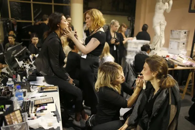 Models have makeup done backstage before designer Hussein Chalayan Spring/Summer 2016 women's ready-to-wear collection show during the Fashion Week in Paris, France, October 2, 2015. (Photo by Charles Platiau/Reuters)