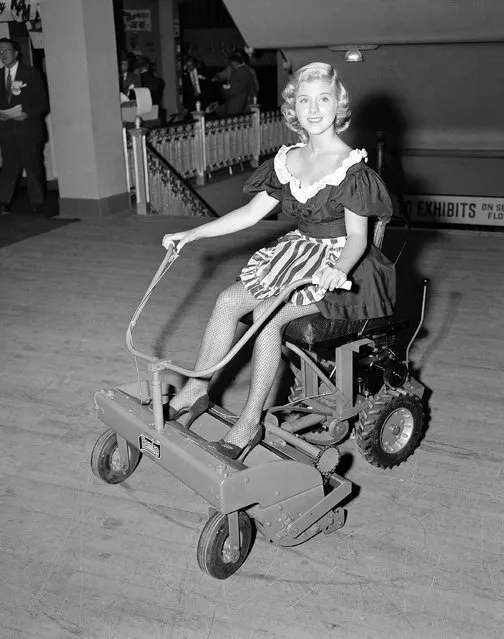 This power lawn mower is one of the new products, large and small, on display at the National Hardware Show in New York, October 8, 1952. Claudia Hall presents the mower which has these features: a 30-inch cutting width, same transmission and differential as an automobile, short wheel base for high maneuverability, cutting speed up to six miles an hour or a rate of an acre of cutting an hour. The power unit is detachable for use elsewhere. The machine, called the 'Hoko", is manufactured by the Western Tool and Stamping Co. of Des Moines, Iowa. (Photo by Robert Kradin/AP Photo)