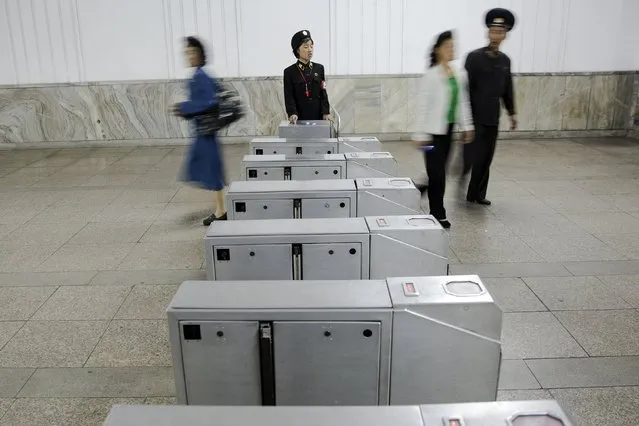 Passengers enter and exit a subway station visited by foreign reporters during a government organised tour in Pyongyang, North Korea, October 9, 2015. (Photo by Damir Sagolj/Reuters)
