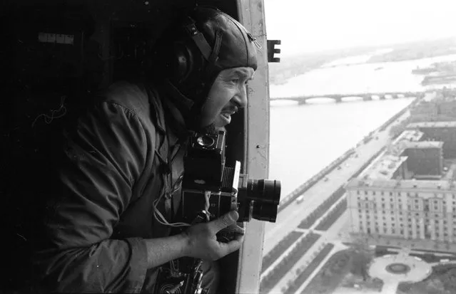 Photographer Vsevolod Tarasevich shooting from a helicopter over Leningrad, Soviet Union, 1960s. (Photo by Oleg Makarov)