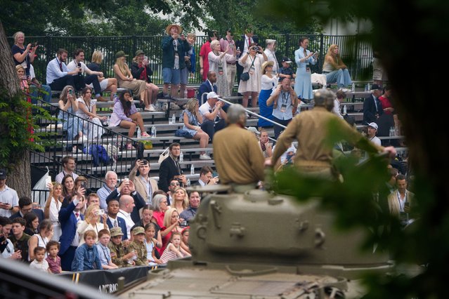 Visitors watch a parade and celebration marking the 250th birthday of the U.S. Army June 14, 2025 in Washington, DC. The U.S. Army is marking its 250th birthday with a military parade including roughly 6,600 troops, 150 vehicles, and over 50 aircraft. The parade, which coincides with President Donald Trump's 79th birthday, is designed to tell the history of the Army. (Photo by Andrew Harnik/Getty Images)