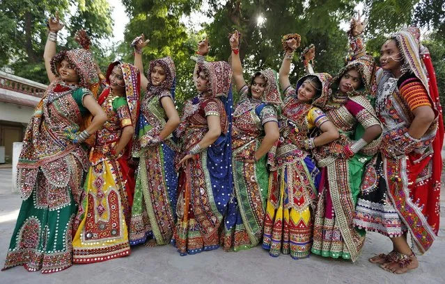 Women dressed in traditional attire pose after taking part in rehearsals for the "garba" dance ahead of Navratri festival in Ahmedabad, India, October 8, 2015. Navratri, held in honour of Hindu Goddess Durga, is celebrated over a period of nine days where thousands of youths dance the night away in traditional costumes. Navratri starts on October 13 this year. (Photo by Amit Dave/Reuters)