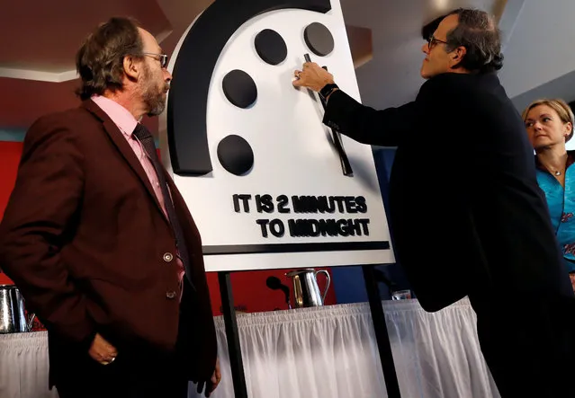 Members of the Bulletin of the Atomic Scientists, (L-R), Lawrence Krauss, Robert Rosner and Sharon Squassoni move the “Doomsday Clock” hands to two minutes until midnight at a news conference in Washington, U.S. January 25, 2018. (Photo by Leah Millis/Reuters)