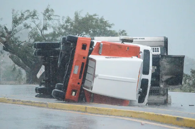 An overturned truck is seen on a highway following the passing of Hurricane Roslyn that hit the Mexico's Pacific coast with heavy winds and rain, in Tecuala in Nayarit state, Mexico on October 23, 2022. (Photo by Liberto Urena/Reuters)