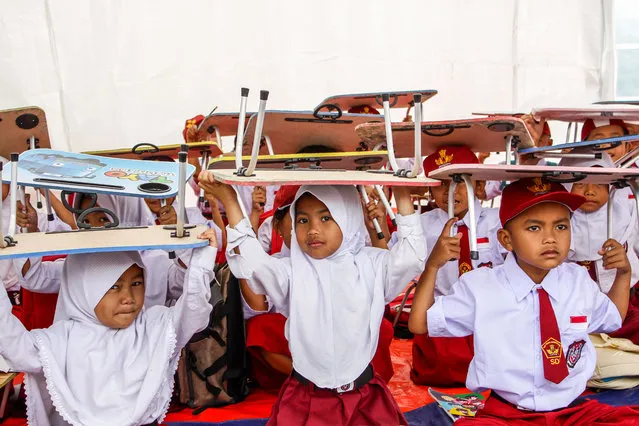 Students attend in makeshift tent classroom during first day of school in Cianjur, West Java, Indonesia on January 9, 2023. A total of 262 students at SDN Citamiang Cianjur studied in makeshift tents due to their schools was damaged by the M 5.6 earthquake. (Photo by Algi Febri Sugita/Avalon)