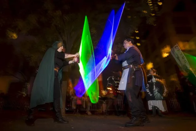 Revelers dressed as characters from Star Wars have a lightsaber battle as they take part in the Greenwich Village Halloween Parade in the Manhattan borough of New York, October 31, 2015. (Photo by Carlo Allegri/Reuters)