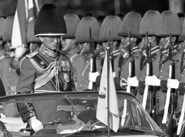 Thai King Bhumibol Adulyadej, the world's longest-reigning monarch, reviews royal guards at an annual trooping of the colours at the Royal Plaza in Bangkok,Thailand in this December 3, 1987 file photo. (Photo by Arthur Tsang/Reuters)