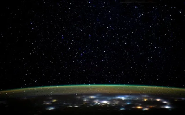 This NASA image obtained on January 5, 2020 shows stars as they glitter in the night sky above the Earth's atmospheric glow, as the International Space Station orbited 260 miles above the Earth as it was about to cross over the Caspian Sea on January 2, 2020. (Photo by Handout/NASA/AFP Photo)