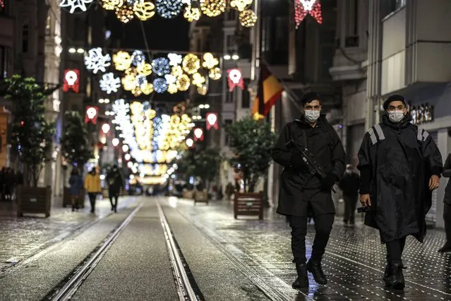 Police officers patrol Istiklal street, the main shopping street in Istanbul, minutes into the lockdown, part of the new measures to try curb the spread of the coronavirus, Saturday, November 21, 2020.Turkey's President Recep Tayyip Erdogan announced a series of restrictions, including partial weekend lockdowns, to help the country grapple with the resurgence of the pandemic. Restaurants and cafes are closed and will only be allowed to serve take-away food. People won't be able to venture out of their homes after 8:00 p.m. on weekends. The restrictions also limit the hours that shops, markets and hairdressers can operate. (Photo by Emrah Gurel/AP Photo)