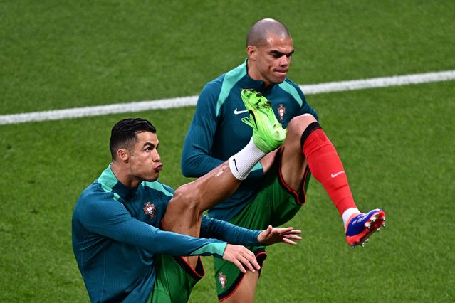Portugal's forward #07 Cristiano Ronaldo and Portugal's defender #03 Pepe (R) warm up prior to the UEFA Euro 2024 Group F football match between Portugal and the Czech Republic at the Leipzig Stadium in Leipzig on June 18, 2024. (Photo by Gabriel Bouys/AFP Photo)