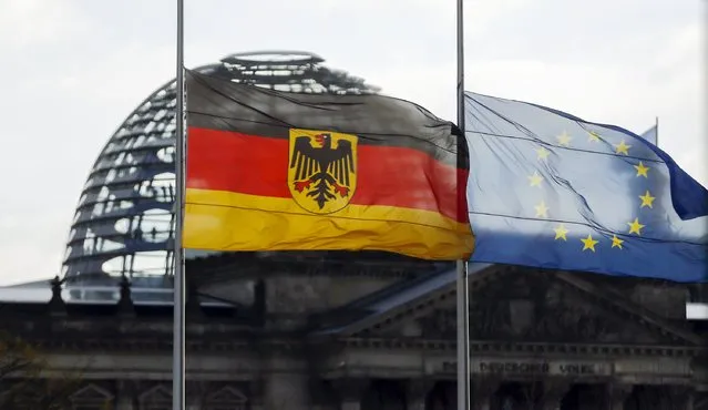 The German and the European Union flags of the chancellery are seen flying at half-mast in front of Reichstag building in Berlin, Germany, November 14, 2015, after the attacks in Paris on Friday. (Photo by Hannibal Hanschke/Reuters)