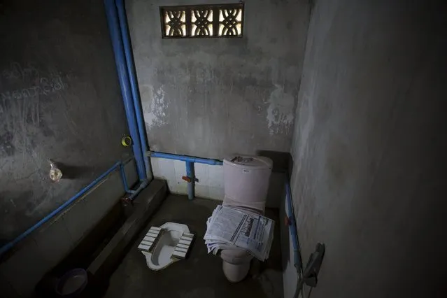 Newspapers lie on a toilet seat in a house in Mandalay, Myanmar, October 5, 2015. (Photo by Jorge Silva/Reuters)