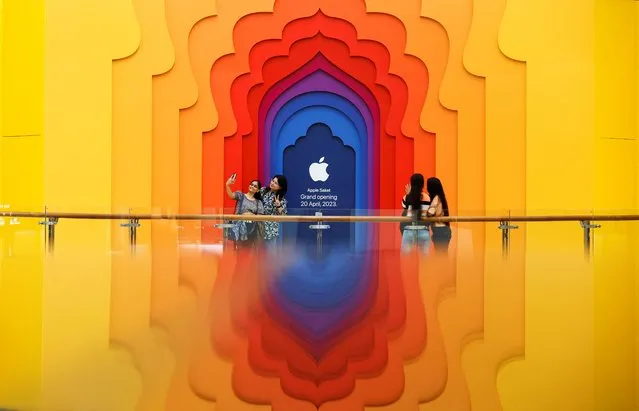 People take pictures outside a soon to be launched Apple retail store at a mall, in New Delhi, India on April 12, 2023. (Photo by Anushree Fadnavis/Reuters)