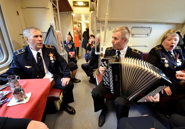 Veterans sing inside the retro train named Pobeda (Victory) during the Victory Day celebrations in the far eastern city of Vladivostok, Russia May 8, 2018. (Photo by Yuri Maltsev/Reuters)